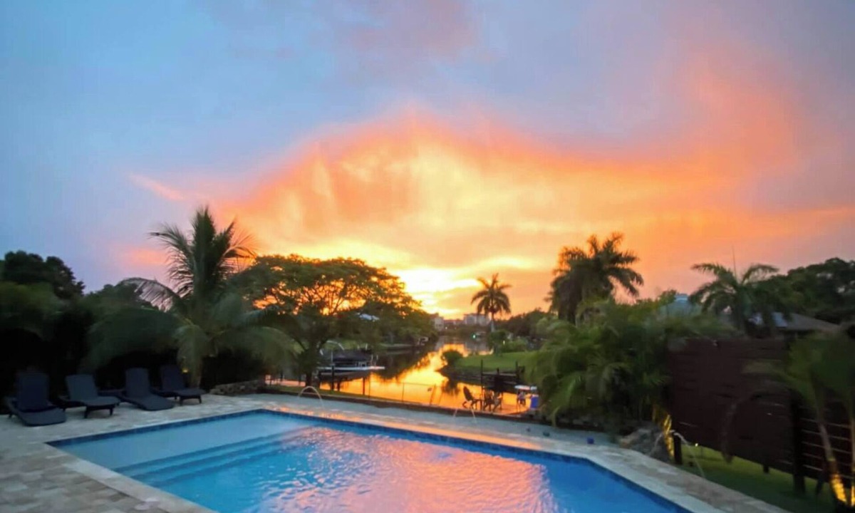 Sarasota House | Waterfront ranch home near Siesta Key with pool overlooking canal and kayaks.
