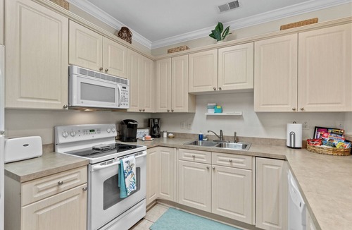 Central Myrtle Beach Condo | Bright and Modern 3BR Family Friendly Condo with pool, golf, Ripken Experience.