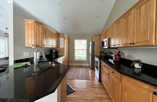 Fennville House | Upscale Wooded Retreat: Heated Pool, Hot tub, Fenced Yard & Game Room.