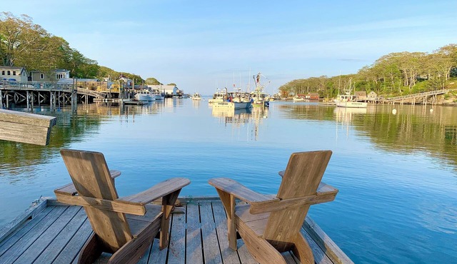 Harborside cabin with dock overlooking lobster boats