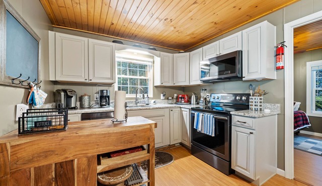 Riverfront oasis with hot tub, firepit, game room, & trail access - dog-friendly in Cherry Log